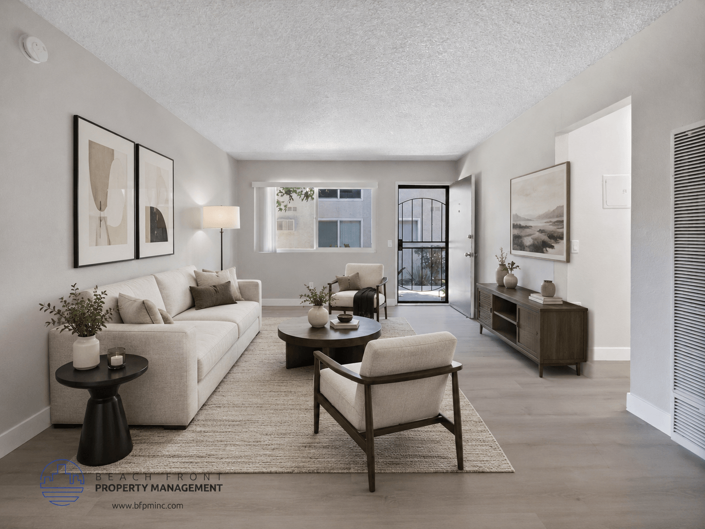 A well-lit living room with a sofa, armchair, and coffee table.
